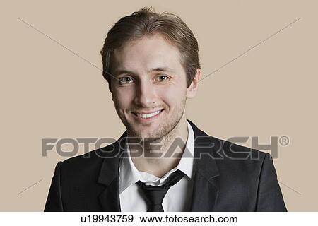 Stock Photo - Portrait of a happy young man over colored background. Fotosearch