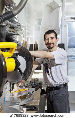 Portrait of a Hispanic employee using circular saw View Large Photo Image Stock Photo - Portrait of a Hispanic employee using circular saw. Fotosearch
