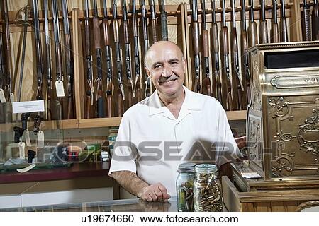Portrait of a mature merchant in gun shop View Large Photo Image Stock Image - Portrait of a mature merchant in gun shop. Fotosearch