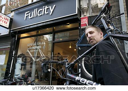 Portrait of a mid adult man carrying bicycle on shoulder View Large Photo Image Stock Image - Portrait of a mid adult man carrying bicycle on shoulder. Fotosearch