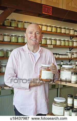 Portrait of a senior man standing with spice jar in store View Large Photo Image Stock Photo - Portrait of a senior man standing with spice jar in store. Fotosearch