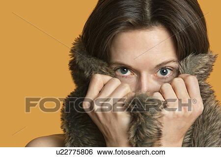 Stock Photograph - Portrait of a woman hiding with fur. Fotosearch