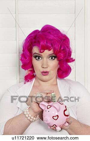 Portrait of a woman saving money in piggy bank View Large Photo Image Stock Image - Portrait of a woman saving money in piggy bank. Fotosearch