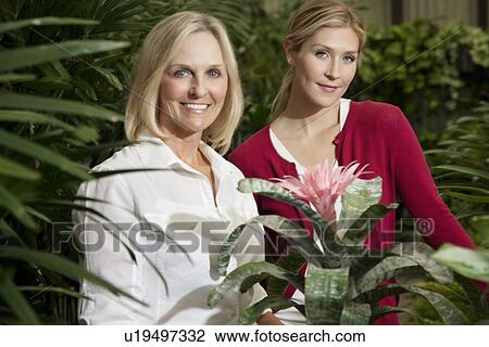 Portrait of a young daughter with senior mother in botanical garden View Large Photo Image Stock Image - Portrait of a young daughter with senior mother in botanical garden. Fotosearch