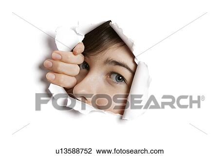 Portrait of a young Middle eastern woman peeking from ripped white paper hole View Large Photo Image Stock Image - Portrait of a young Middle eastern woman peeking from ripped white paper hole. Fotosearch