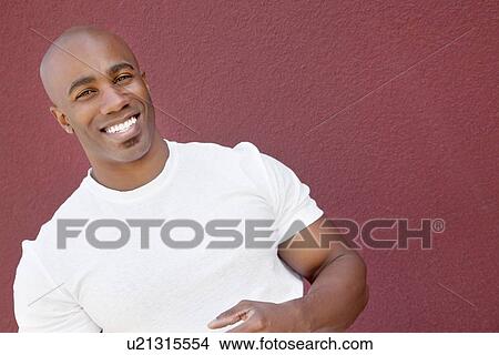 Portrait of a young muscular man over colored background View Large Photo Image Picture - Portrait of a young muscular man over colored background. Fotosearch