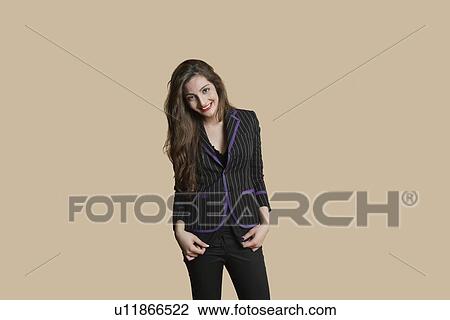 Portrait of beautiful young woman in formals over colored background View Large Photo Image Stock Image - Portrait of beautiful young woman in formals over colored background. Fotosearch