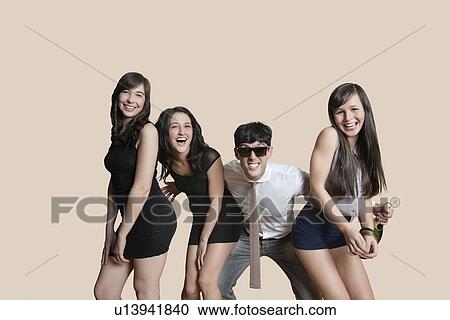 Portrait of cheerful young friends posing over colored background View Large Photo Image Stock Image - Portrait of cheerful young friends posing over colored background. Fotosearch