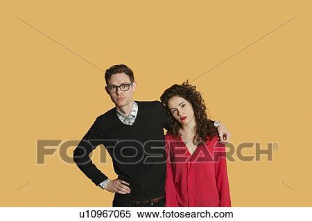 Stock Photography - Portrait of friends standing together over colored background. Fotosearch