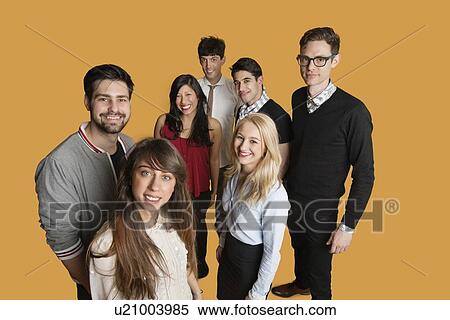 Portrait of group of friends standing together over colored background View Large Photo Image Stock Photography - Portrait of group of friends standing together over colored background. Fotosearch