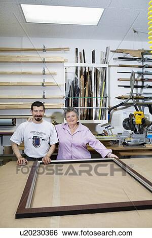 Portrait of happy senior owner with mature employee in frame workshop View Large Photo Image Stock Photograph - Portrait of happy senior owner with mature employee in frame workshop. Fotosearch
