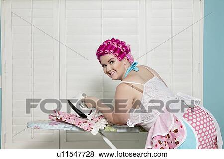 Portrait of happy young woman ironing View Large Photo Image Stock Photo - Portrait of happy young woman ironing. Fotosearch