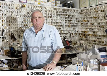 Stock Photography - Portrait of locksmith in store. Fotosearch