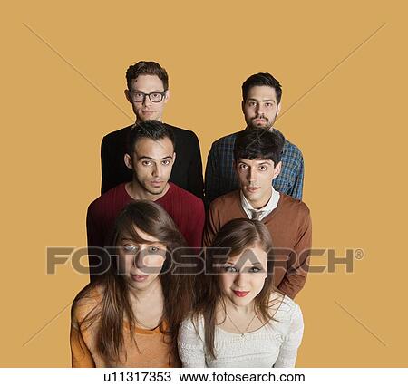 Stock Image - Portrait of multiethnic group of friends over colored background. Fotosearch