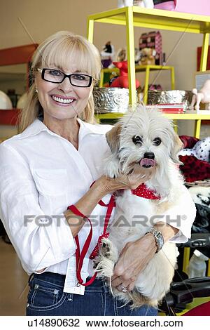Portrait of pet shop owner carrying dog View Large Photo Image Stock Image - Portrait of pet shop owner carrying dog. Fotosearch