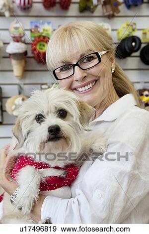 Stock Photo - Portrait of senior pet owner shop with dog. Fotosearch