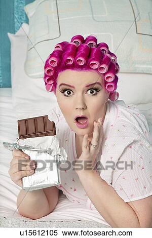 Portrait of shocked woman with chocolate lying on bed View Large Photo Image Stock Photography - Portrait of shocked woman with chocolate lying on bed. Fotosearch