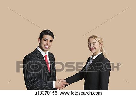 Portrait of young business people shaking hands over colored background View Large Photo Image Stock Photograph - Portrait of young business people shaking hands over colored background. Fotosearch