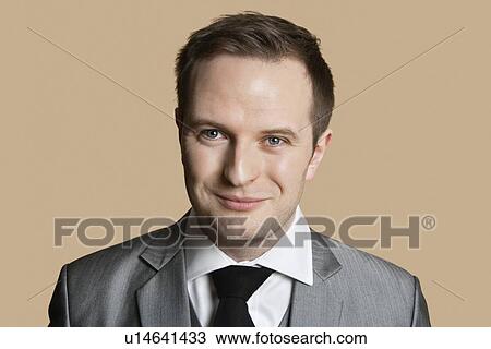 Portrait of young businessman over colored background View Large Photo Image Stock Image - Portrait of young businessman over colored background. Fotosearch