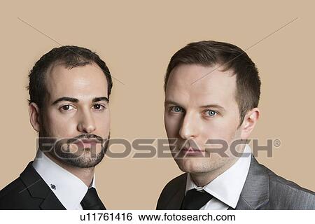Portrait of young businessmen over colored background View Large Photo Image Stock Photograph - Portrait of young businessmen over colored background. Fotosearch