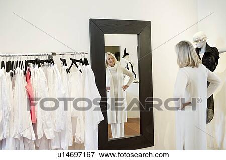 Senior woman looking at herself in mirror View Large Photo Image Stock Photo - Senior woman looking at herself in mirror. Fotosearch