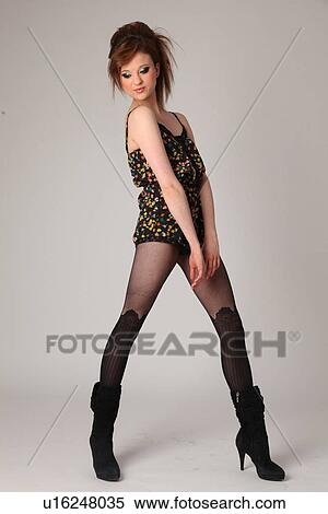 Stock Photography - Sexy young woman posing over colored background. Fotosearch