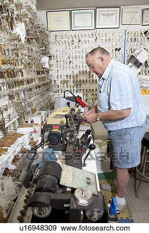 Side view of senior locksmith working in store View Large Photo Image Stock Photo - Side view of senior locksmith working in store. Fotosearch