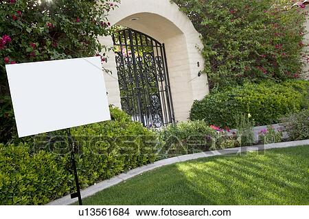 Sign board on lawn with house in background View Large Photo Image Picture - Sign board on lawn with house in background. Fotosearch