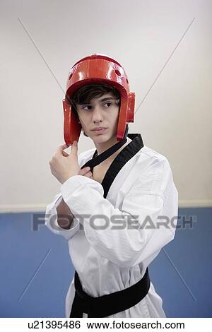 Teenage boy wearing martial arts headgear while looking away View Large Photo Image Stock Photograph - Teenage boy wearing martial arts headgear while looking away. Fotosearch