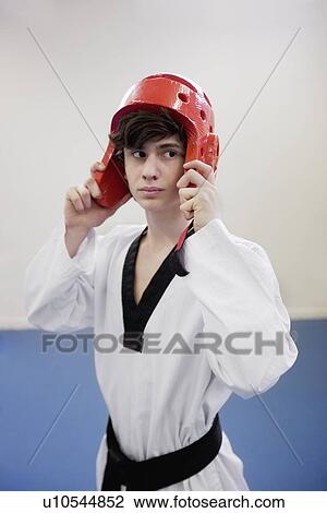 Teenage boy wearing protective headgear in practice session View Large Photo Image Stock Image - Teenage boy wearing protective headgear in practice session. Fotosearch