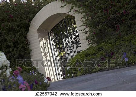 Stock Image - Tilt shot of entrance gate of house. Fotosearch