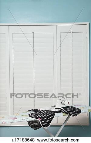 View of iron on board with clothes View Large Photo Image Stock Photo - View of iron on board with clothes. Fotosearch