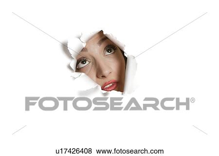 Young Middle eastern woman looking up from ripped paper hole View Large Photo Image Stock Photo - Young Middle eastern woman looking up from ripped paper hole. Fotosearch