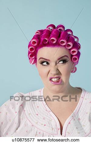Young woman making face over colored background View Large Photo Image Stock Photo - Young woman making face over colored background. Fotosearch