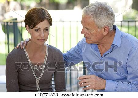 Stock Photo - Absence seizure. Man looking after a woman who is having an absence seizure.. Fotosearch