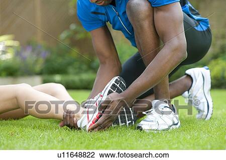 Ankle injury. Female runner with an ankle injury. View Large Photo Image Stock Image - Ankle injury. Female runner with an ankle injury.. Fotosearch