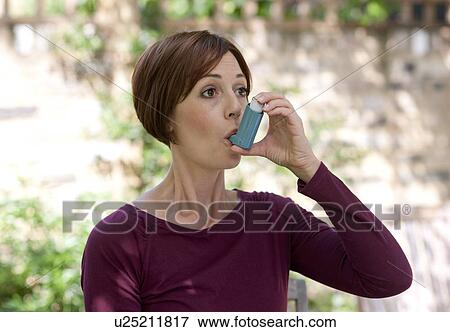 Asthma inhaler use. View Large Photo Image Stock Photo - Asthma inhaler use.. Fotosearch