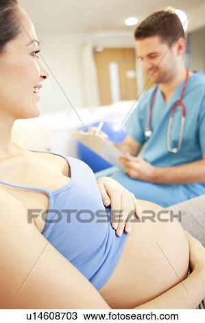 Birthing centre. Midwife checking on a pregnant woman in a room at a birthing centre. View Large Photo Image Stock Image - Birthing centre. Midwife checking on a pregnant woman in a room at a birthing centre.. Fotosearch