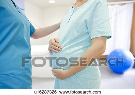 Birthing centre. Pregnant woman during early labour at a birthing centre. View Large Photo Image Stock Photograph - Birthing centre. Pregnant woman during early labour at a birthing centre.. Fotosearch