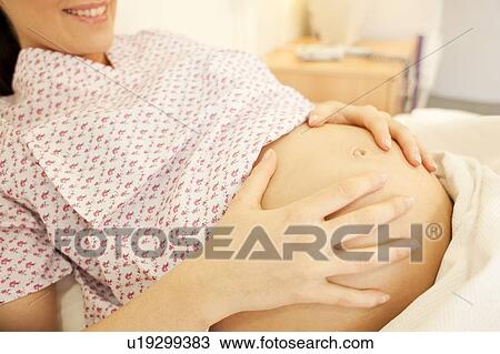 Stock Image - Birthing centre. Pregnant woman in a room at a birthing centre.. Fotosearch