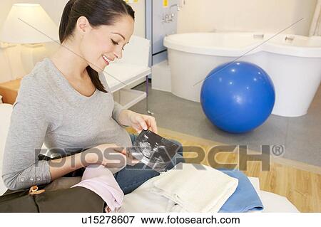 Birthing centre. Pregnant woman unpacking in her room at a birthing centre. View Large Photo Image Stock Photo - Birthing centre. Pregnant woman unpacking in her room at a birthing centre.. Fotosearch