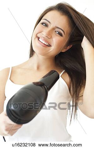 Blow dry. Teenage girl blow drying her hair. View Large Photo Image Stock Photo - Blow dry. Teenage girl blow drying her hair.. Fotosearch