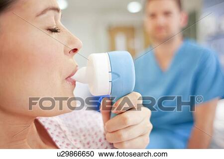 Stock Image - Childbirth. Pregnant woman taking gas and air during childbirth.. Fotosearch