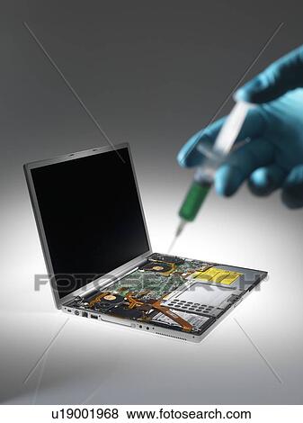 Stock Photo - Computer virus. Conceptual image of a laptop being infected with a virus.. Fotosearch