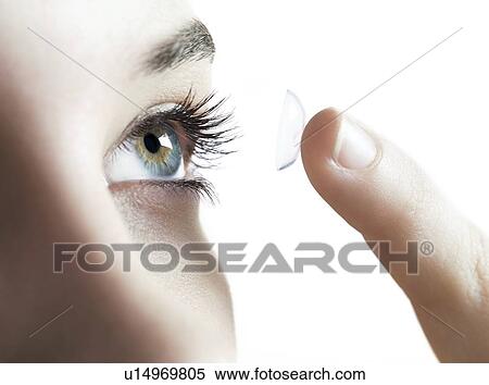 Contact lens use. Woman putting in a contact lens. View Large Photo Image Stock Photography - Contact lens use. Woman putting in a contact lens.. Fotosearch
