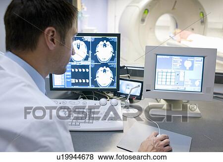 CT scanning. Radiographer taking a computed tomography (CT) scan of a patient. View Large Photo Image Stock Photo - CT scanning. Radiographer taking a computed tomography (CT) scan of a patient.. Fotosearch