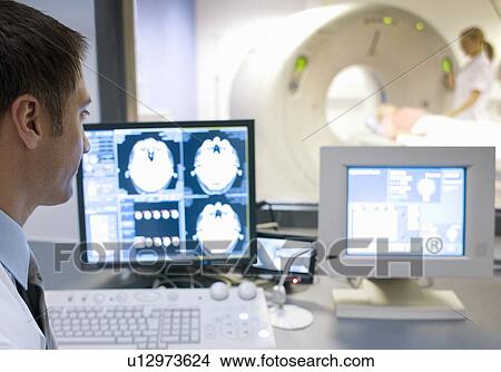 Picture - CT scanning. Radiographers taking a computed tomography (CT) scan of a patient.. Fotosearch