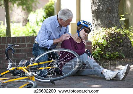 Cycling accident. Man helping a cyclist that has fallen from her bike. View Large Photo Image Stock Image - Cycling accident. Man helping a cyclist that has fallen from her bike.. Fotosearch