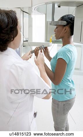 Dental X-ray. Woman having a panorex panoramic dental X-ray taken. View Large Photo Image Stock Image - Dental X-ray. Woman having a panorex panoramic dental X-ray taken.. Fotosearch