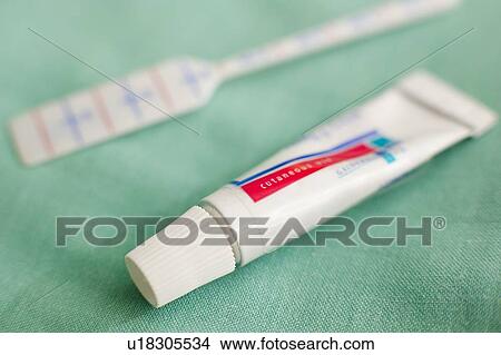 Picture - Dermatological prodrug cream and applicator. This cream is used during photodynamic light therapy.. Fotosearch